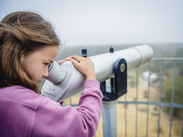 Meisje kijkt door telescoop op de uitkijktoren in Gerhagen